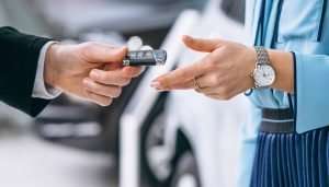 Female hands close up with car keys