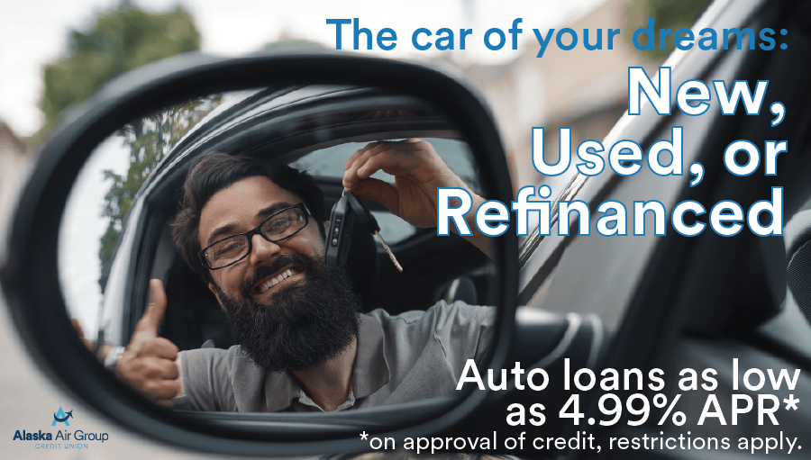 Man looks out the open window of his new car holding up the keys with a thumbs up. Overlaid text reads "The car of your dreams, new, used, or refinanced. Auto loans as low as 4.99% APR* *On approval of credit, restrictions apply."