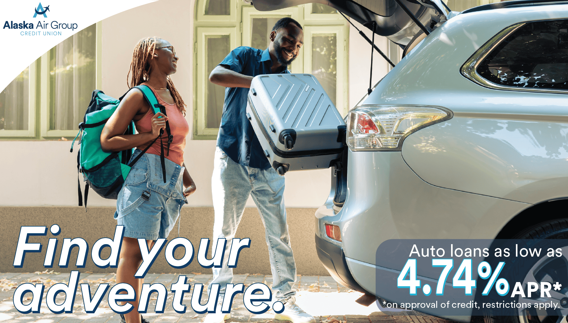 A young couple loads suitcases into the back of an SUV. Overlaid text reads "Find your adventure. Auto loans as low as 4.74% APR* *On approval of credit, restrictions apply."